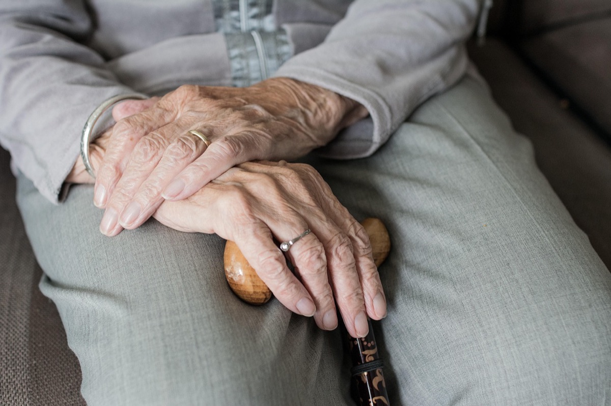 Close up of hands holding a medical insurance card representing Medicare.