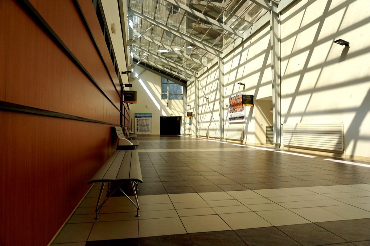 Modern hospital corridor with white walls and medical equipment