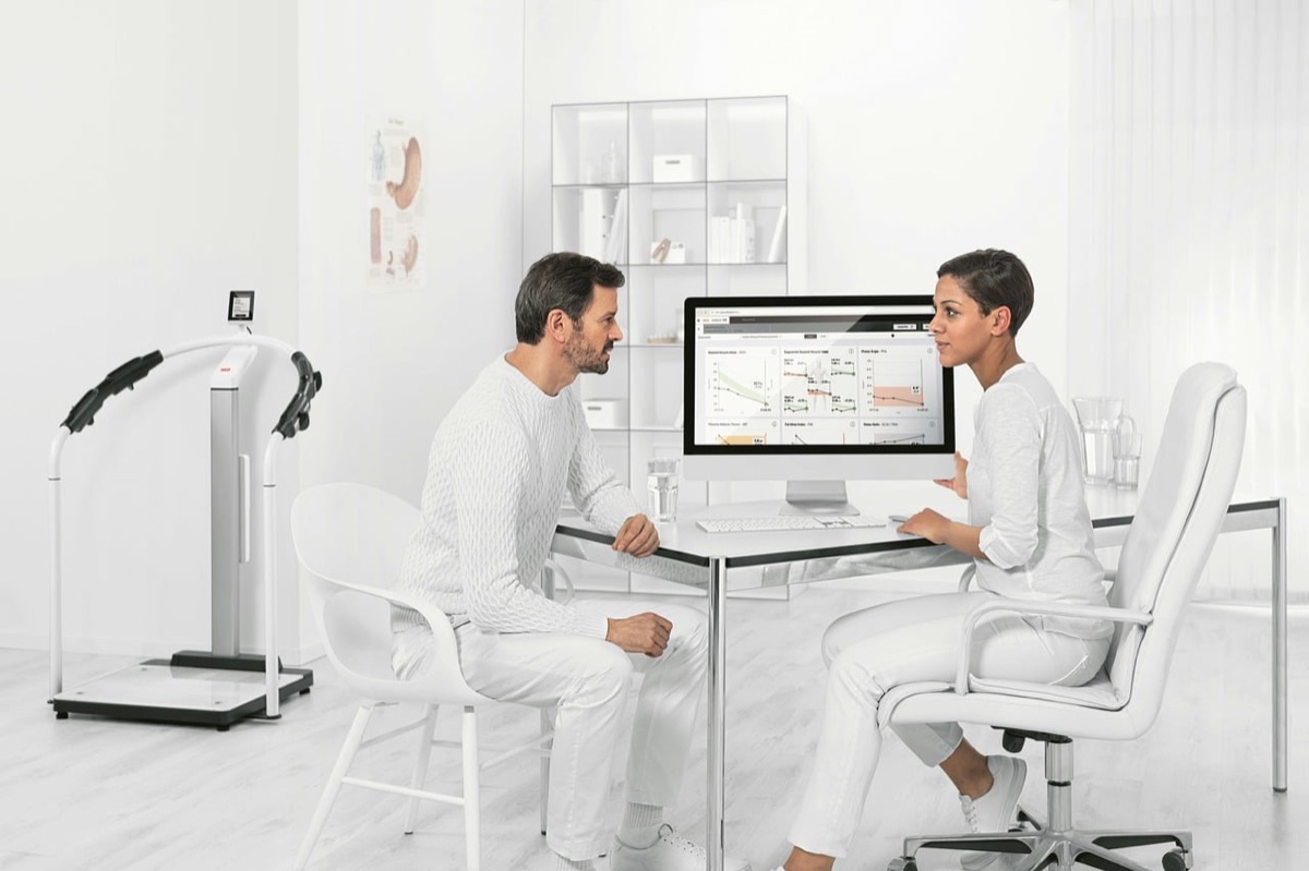 medical staff in white coats discussing patient care in hospital