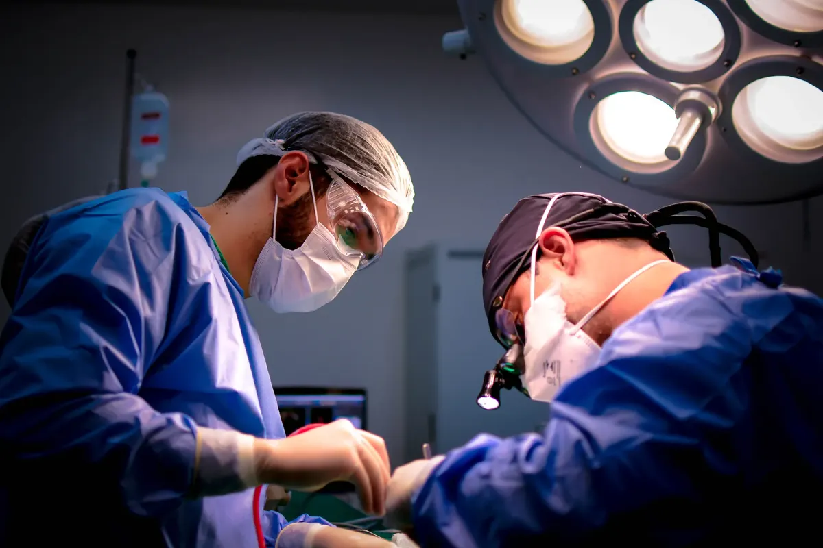 Focused surgeons performing a meticulous operation in a hospital operating room.